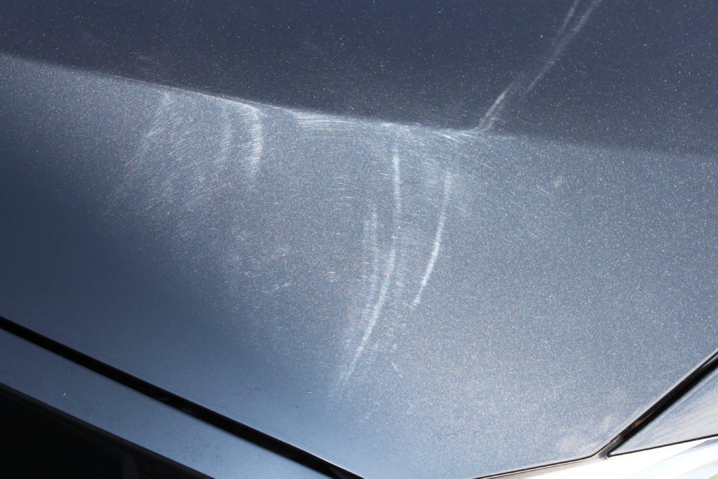 BMW Sapphire Black Metallic paint on the hood with lots of swirls 