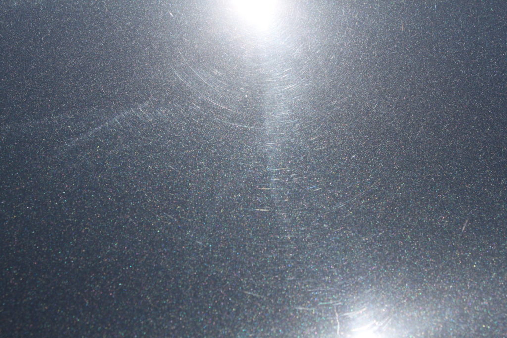 BMW Sapphire Black Metallic paint on the trunk with lots of swirls 