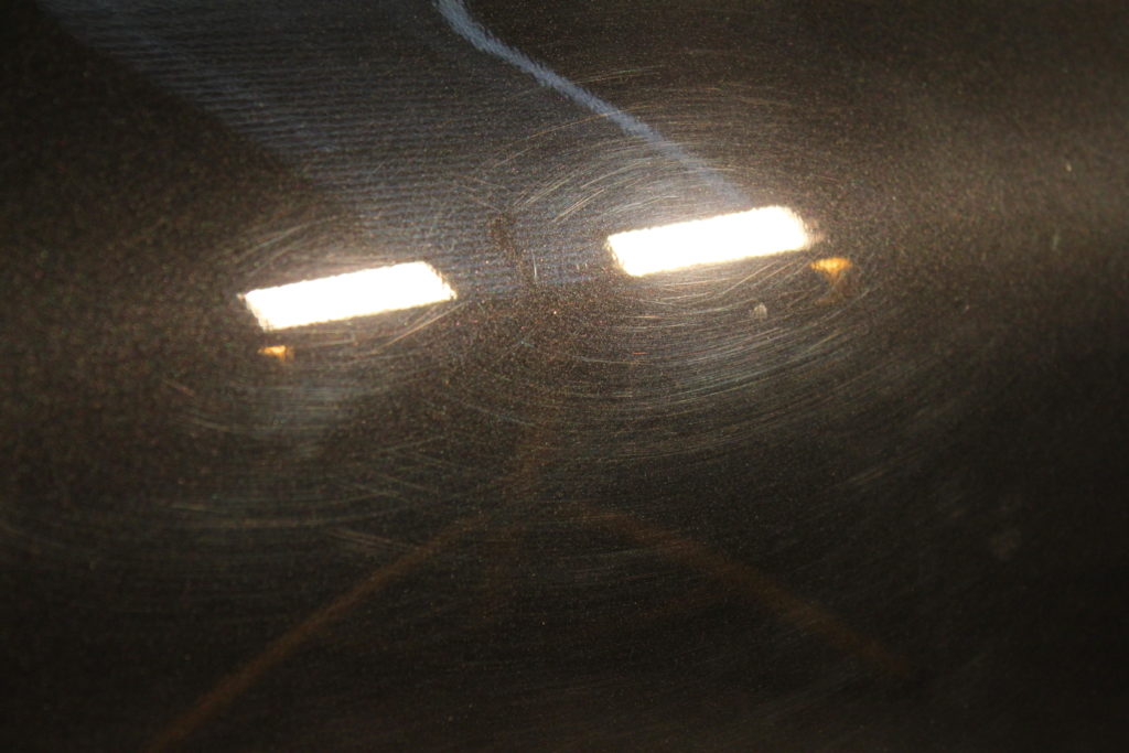 Close up of paint swirls under a work light.