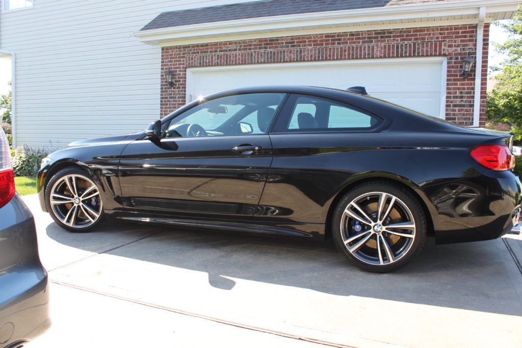 Side view of the black BMW 435i after all the detailing work is complete.